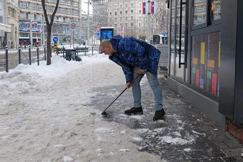 İnsanlar belirsizlik içinde Beograd'da kar temizleme çalışmalarını izliyor